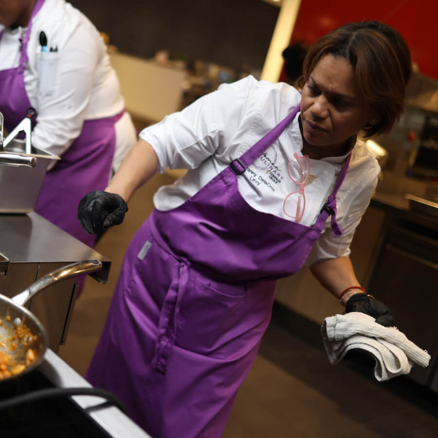 woman chef cooking food on a stove - Mobile Version