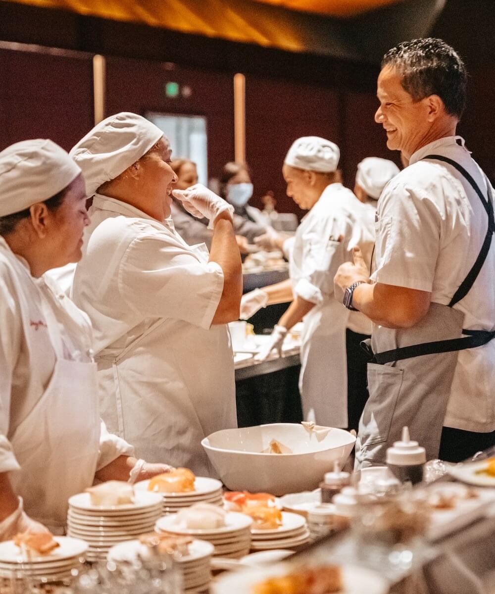 chefs laughing while prepping food - Mobile