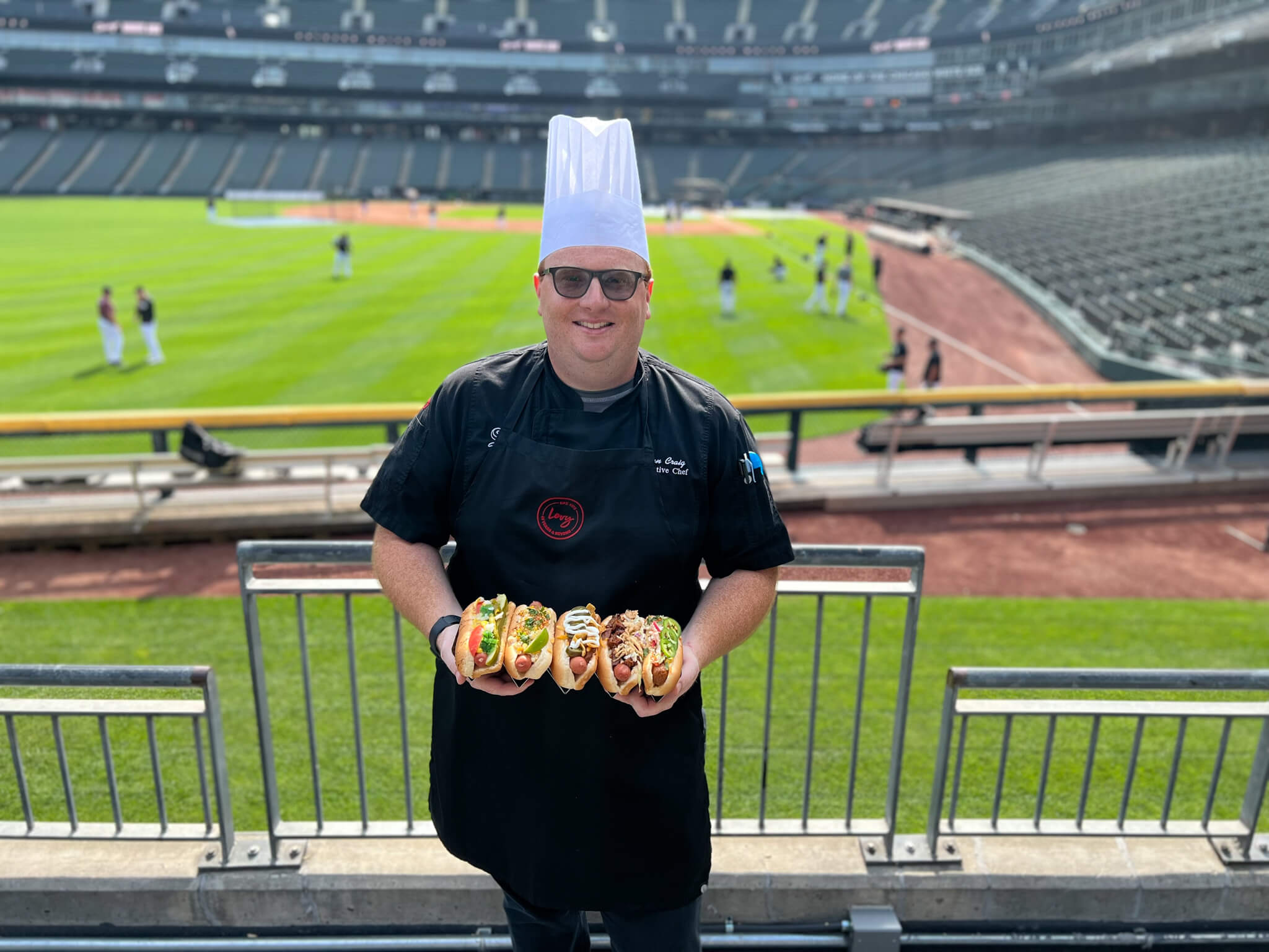 Chef Holding Hot Dogs