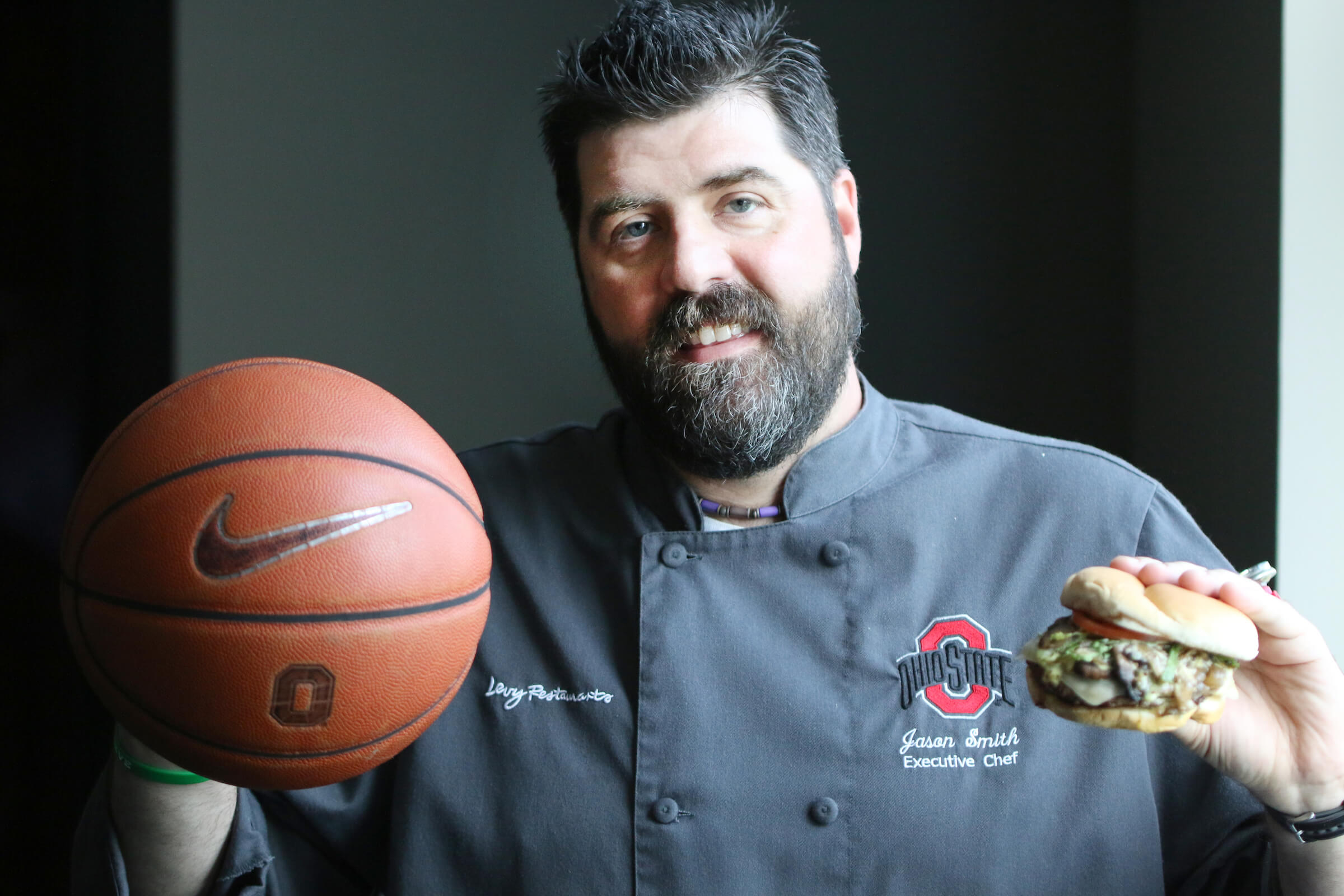 executive chef holding a sandwich