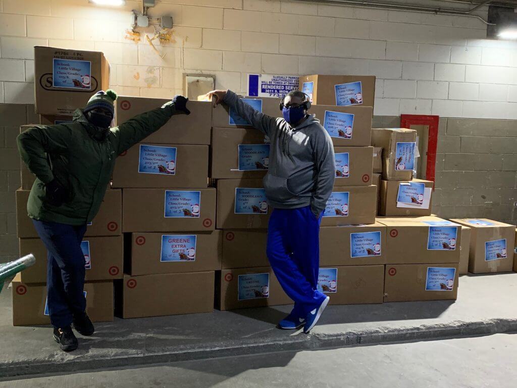 Two workers, Shamar and Corey, with boxes for Project Great Elf