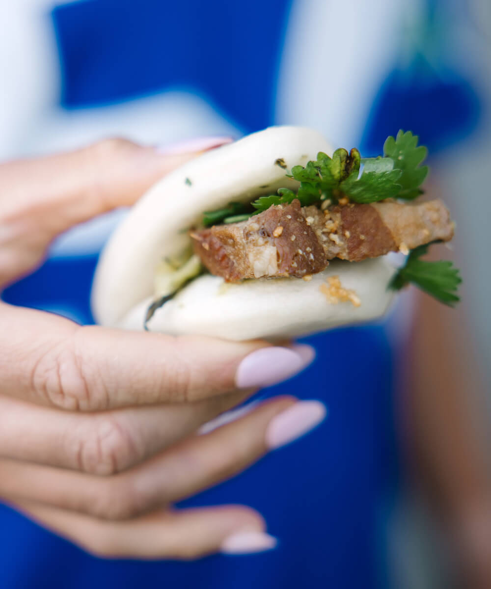 woman holding a bao bun - mobile version